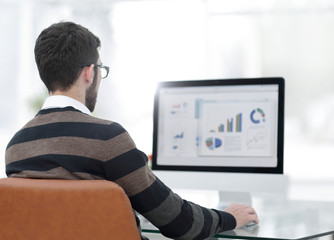 Sticker - businessman analyzing graphs on computer at desk