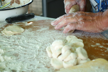 Wall Mural - Home-made recipe for dumplings (raviol)i. Traditionally, women of the older generation mold the dumplings in the family.