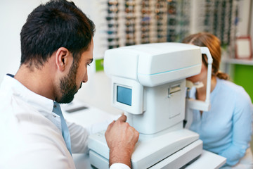 Wall Mural - Eye Test. Optometrist Testing Woman Eyesight On Modern Equipment