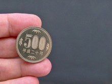 Close Up On 500 Coins With Hand Holding. Japanese Yen With The Copy Space For Free Text