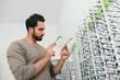 © puhhha - Glasses Shop. Man Trying On Eyeglasses In Optics Store