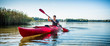 © Kzenon - Portrait of man kayaking on idyllic lake using paddle