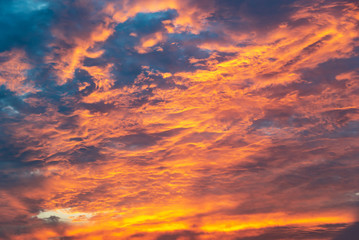 Wall Mural - dramatic orange sky with clouds at sunset