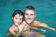 © jovannig - Happy father and daughter relaxing in a pool at night