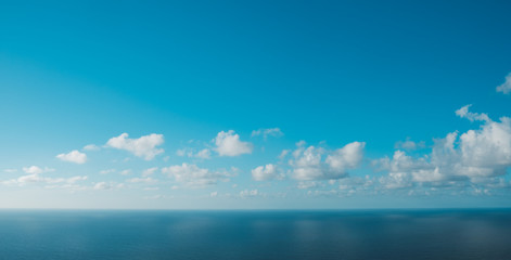 Wall Mural -  blue sky  above ocean horizon with clouds