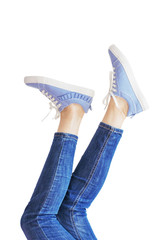 Woman legs in a blue jeans on white background isolated