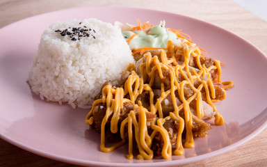 Wall Mural - Deep fried chicken cutlet served with rice and coleslaw, topped with cheese. Taken in Singapore.