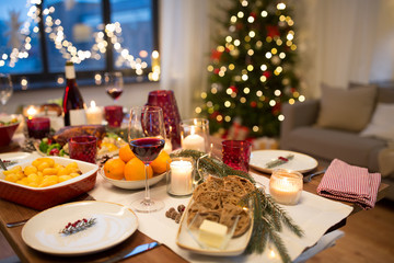  christmas dinner and eating concept - food and drinks on table at home