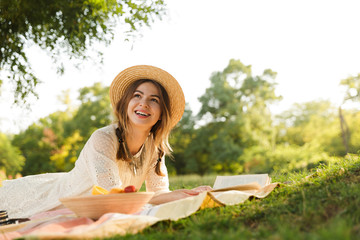 Sticker - Lovely young girl in summer hat having a picnic