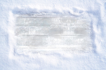 Wall Mural - winter christmas snowy frame with copy space. wooden light boards are covered with snow with clean f