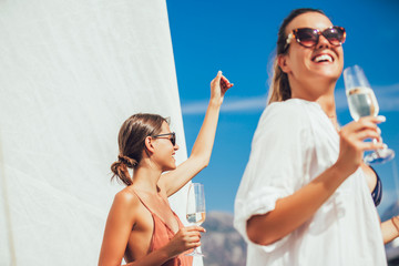 Wall Mural -  Girls enjoy the vacation on a yacht. Party on a sailboat.