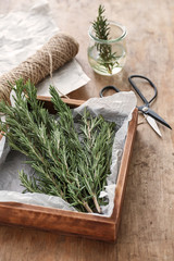 Wall Mural - Box with fresh rosemary on wooden table