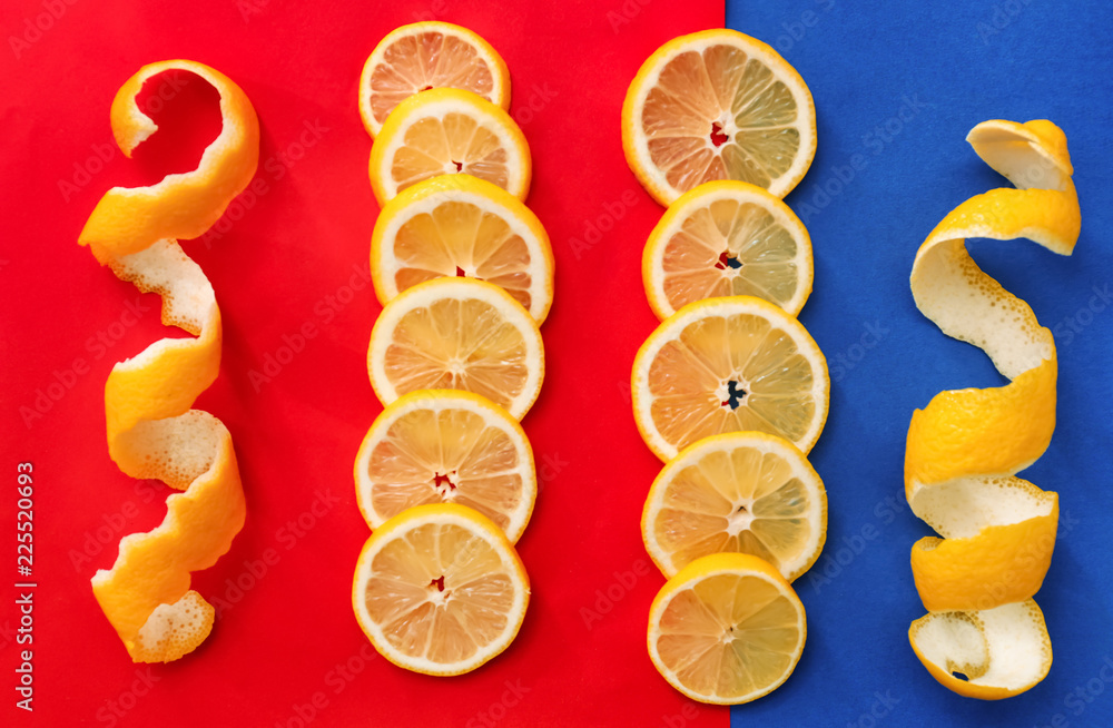Lemon slices and peel on color background, top view