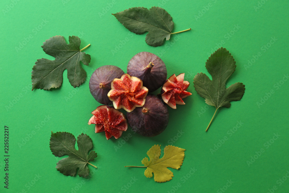 Flat lay composition with fresh ripe purple figs on color background