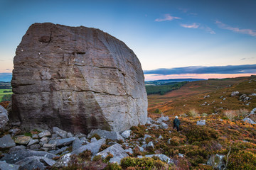 Canvas Print - Drake Stone with man / The Drake Stone at Harbottle in Northumberland is a huge 30 feet tall sandstone boulder reputed to have special healing powers