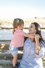 Wall Mural - Mother and daughter playing at the park