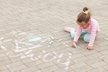 Wall Mural - little girl draws a chalk