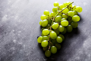 Green grapes on black stone. Copyspace