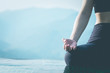 © 220 Selfmade studio - Close up Hand of woman practice yoga Lotus pose on the pool above the Mountain peak in the morning in front of beautiful nature views in SAPA vietnam,Feel so comfortable and relax