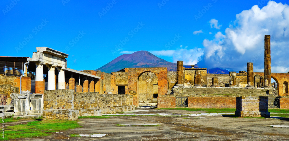 View of the roman ruins destroyed by the eruption of Mount Vesuvius centuries ago at Pompeii Archaeological Park in Pompei, Italy. - obrazy, fototapety, plakaty 