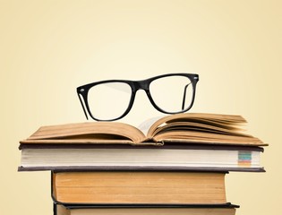 Wall Mural - black glasses on open books