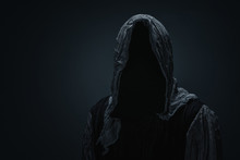 Silhouette Of Grim Reaper Over Dark Gray Background With Copy Space