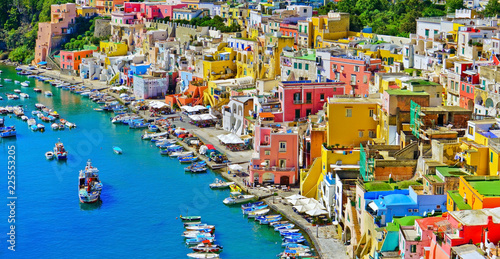 View of the Port of Corricella with lots of colorful houses on a sunny day in Procida Island, Italy. © Javen