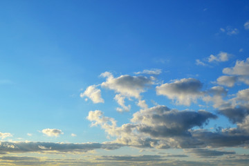 Wall Mural - light white clouds high in a blue sky on a sunny day background