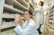 © auremar - two pharmacist chemist women working in pharmacy drugstore