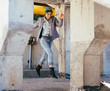 © Nikita Vasylchenko - A modern woman in the city. Hipster on the background of concrete structures