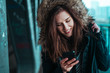 © SVP Productions - Beautiful young brunette looking at her phone under the bridge