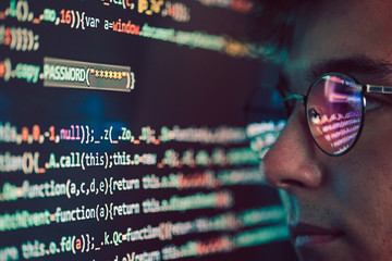 hacker using computer, smartphone and coding to steal password and private data
