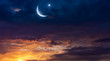 © yaalan - Crescent moon with beautiful sunset background .  Light from sky . Religion background . beautiful sky . Yellow and pink clouds . Sunset and new moon . Prayer time . Generous Ramadan