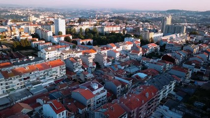 Wall Mural - Flying over Dom Luis I iron bridge across Douro river early morning in Porto, Portugal. Aerial view of the old city center.
