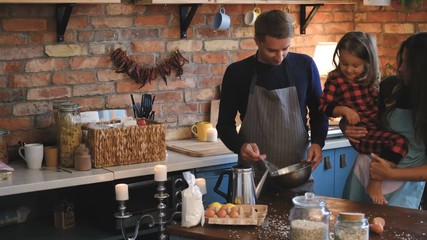 Wall Mural - Family together cooking breakfast in loft style kitchen.