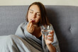 © deineka - Sick woman taking pills, at home