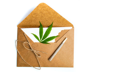 Wall Mural - Marijuana leaf in an envelope on white