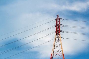 High-voltage pylon with blue sky