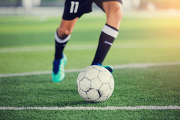 Wall Mural - Soccer player speed run to shoot ball to goal on artificial turf.