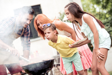 Wall Mural - Young family make barbecue at their home