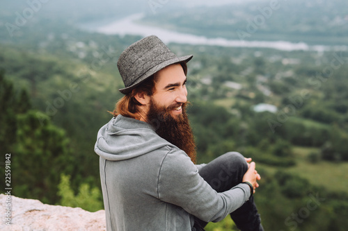 Young Bearded Cheerful Tourist Looks At Summer Beautiful