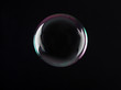canvas print picture - Beautiful translucent soap bubble on dark background. Space for text