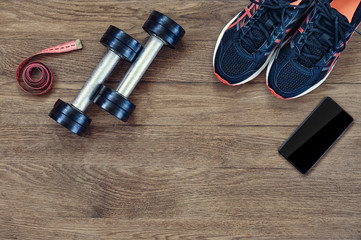 Wall Mural - Different fitness equipment on the wooden background