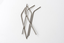 Directly Above View Of Five Metal Straws Randomly Arranged On White Background