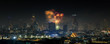 panorama view of beautiful firework explosion over bangkok city skyscraper