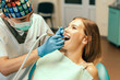 © bedya - Dentist examine female patient with braces in denal office.