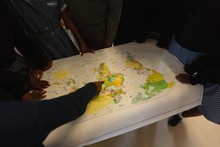 Schoolkids Looking At World Map In Classroom