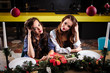 © cherry_d - Pretty twins young women together in a kitchen room, casual home style, new year and christmas decorations