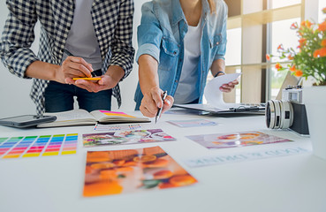 asian advertising designer creative start-up team discussing ideas in office.