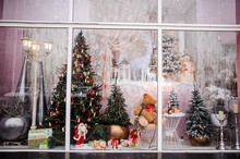 Beautiful Festive Christmas Storefront With Decorated Artificial Christmas Trees And Toys